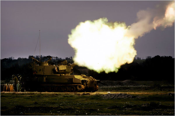 On the ninth day of Israels war against Gaza, an Israeli army mobile artillery piece fire toward targets in the southern Gaza Strip, January 4, 2009.