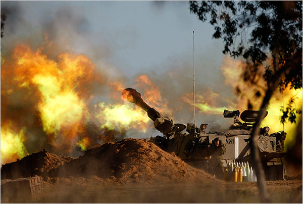 On the eleventh day of Israel’s war against Gaza, an Israeli mobile artillery unit fires a shell towards Gaza, January 6, 2009.
