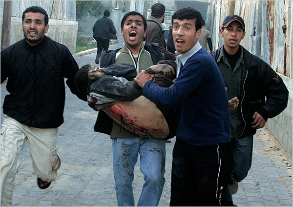 On the eleventh day of Israels war against Gaza, a wounded Palestinian is carried near a United Nations school, Gaza City, January 6, 2009.