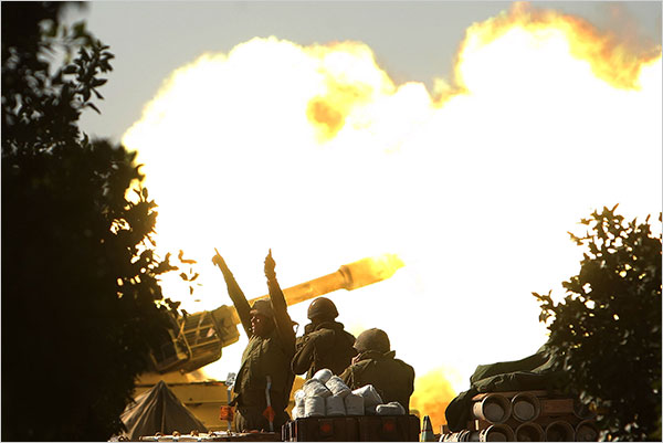 On the twelfth day of Israels war against Gaza, an Israeli mobile artillery unit fires a shell into Gaza before the commencement of the temporary cease-fire, January 7, 2009.
