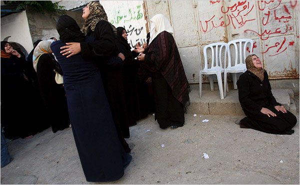 On the twelfth day of Israels war against Gaza, women grieve during a funeral for ten family members killed in a missile strike, January 7, 2009.