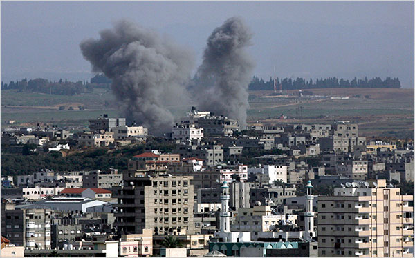 On the thirteenth day of Israels war against Gaza, smoke rises as an Israeli missile strikes in the east of Gaza City, January 8, 2009.