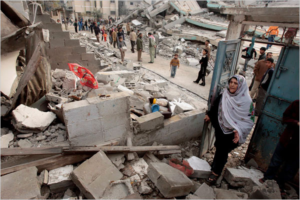 On the thirteenth day of Israels war against Gaza, a Palestinian woman looks at her house, which was destroyed in an Israeli air strike, January 8, 2009.