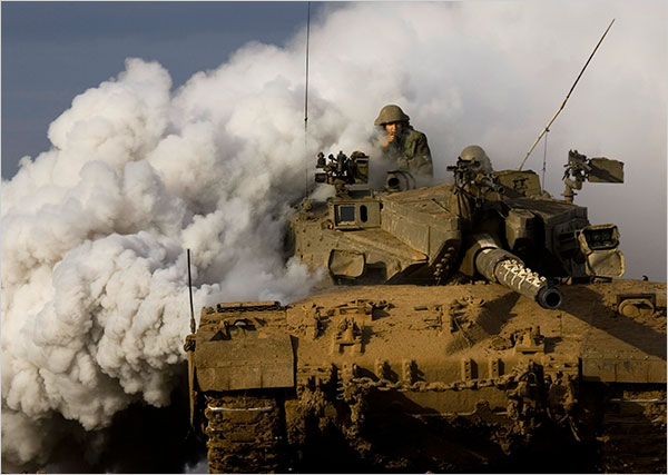 On the thirteenth day of Israels war against Gaza, an Israeli tank advances along the Gaza border, January 8, 2009.
