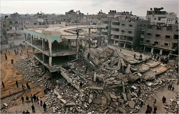 On the thirteenth day of Israel’s war against Gaza, Palestinians gather around the ruins of Al Noor Mosque destroyed by an Israeli airstrike in the Sheikh Radwan neighborhood of Gaza City, January 8, 2009.