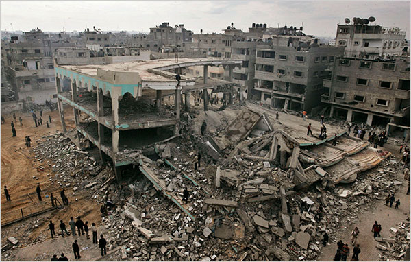 On the thirteenth day of Israels war against Gaza, Palestinians gather around the ruins of Al Noor Mosque destroyed by an Israeli airstrike in the Sheikh Radwan neighborhood of Gaza City, January 8, 2009.