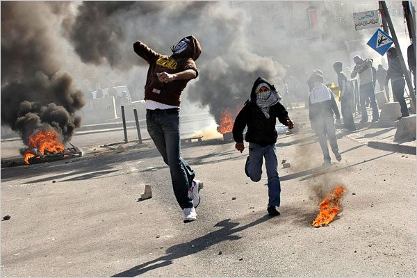On the fourteenth day of Israels war against Gaza, Palestinian youths throw stones during minor clashes with Israeli police officers after a protest in Jerusalem, January 9, 2009.