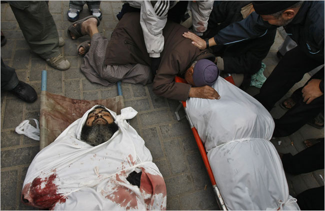 On the sixteenth day of Israels war against Gaza, Palestinians mourn over the bodies of relatives, Gaza City, January 11, 2009.