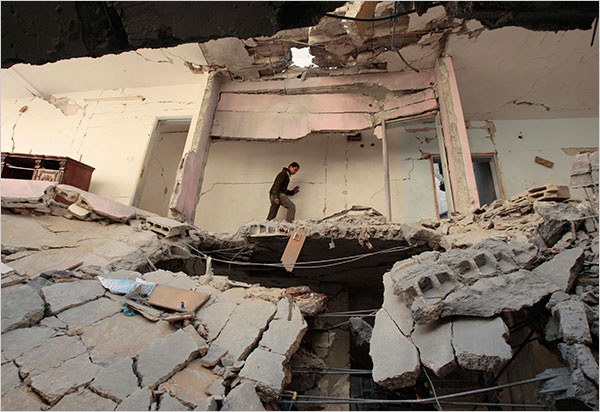 On the seventeenth day of Israels war against Gaza, a Palestinian walks amid the rubble of a house destroyed after an Israeli airstrike in the northern Gaza Strip, January 12, 2009.