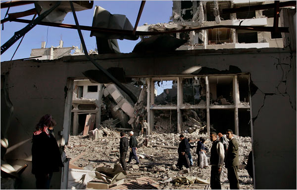 On the eighteenth day of Israels war against Gaza, Palestinians survey the damage to a building following an Israeli airstrike, Gaza City, January 13, 2009.