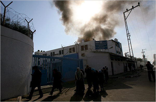 On the twentieth day of Israels war against Gaza, Palestinian families walk near the U.N. headquarters after the Israeli bombardment, January 15, 2009.