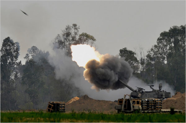 On the twenty-second day of Israels war against Gaza, Israeli forces fire a long-range shell toward the Gaza Strip, January 17, 2009.