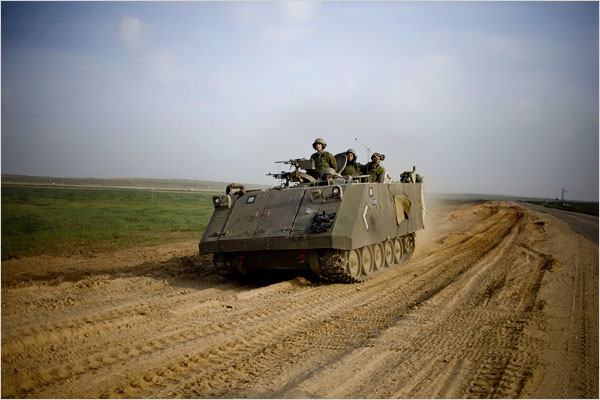 On the twenty-second day of Israels war against Gaza, an Israeli armored vehicle move toward Gaza from the Israeli side of the border, January 17, 2009.