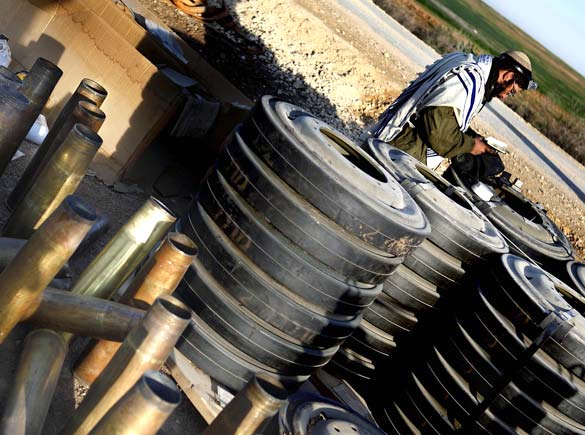On the twentieth day of Israels war against Gaza, an Israeli soldier prays near spent ammunition before his unit enters the northern Gaza Strip, January 15, 2009.