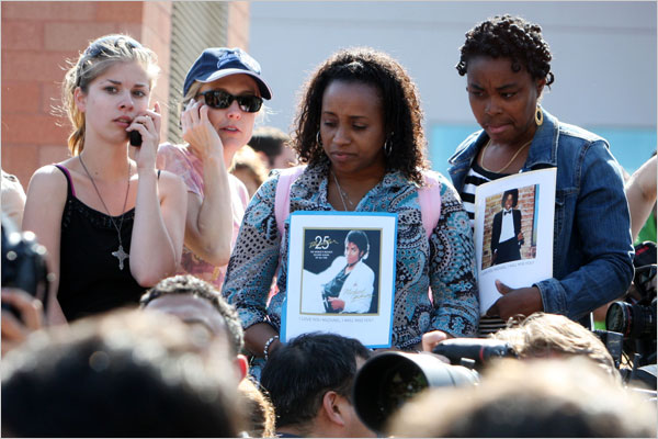 Hundreds of Michael Jackson's fans gather outside the U.C.L.A. Medical Center, where he was rushed to, holding photographs and chanting his name, June 25, 2009.