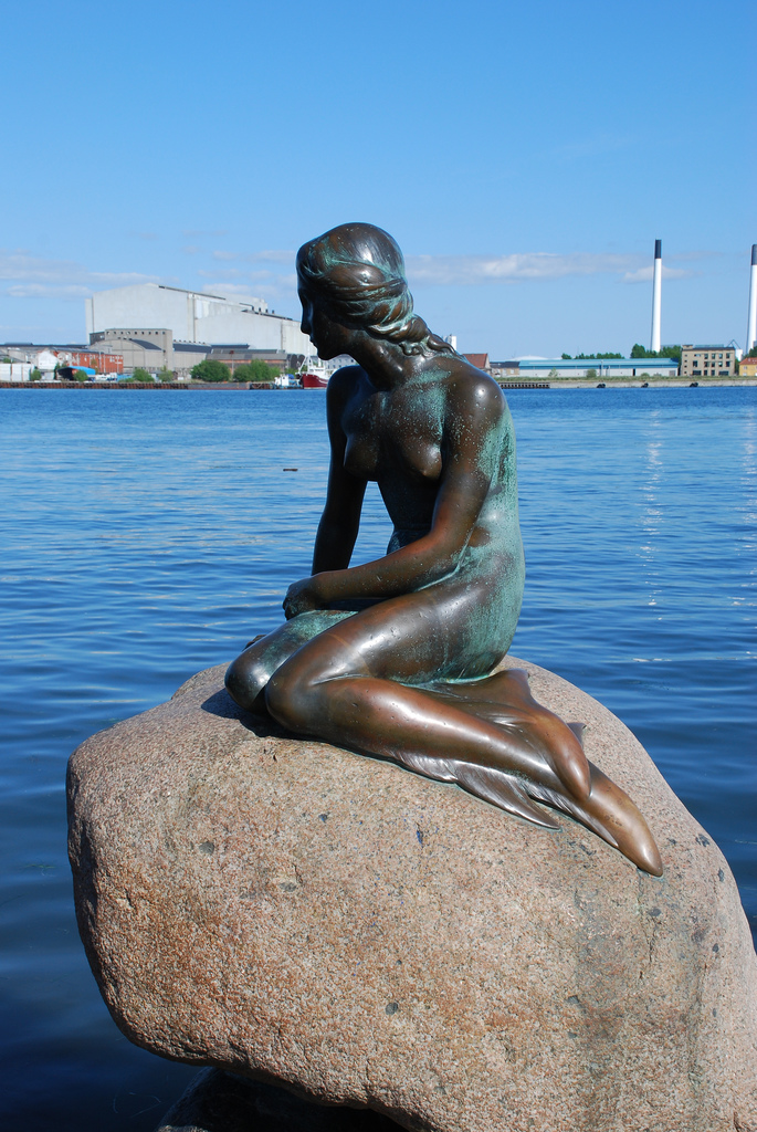 The Little Mermaid statue, in tribute of the fairy tale by Hans Christian Andersen, commissioned in 1909 by Carl Jacobsen (son of the founder of Carlsberg Breweries), and finished in 1913 by sculptor Edvard Eriksen, as photographed in 2009, Copenhagen Harbor.