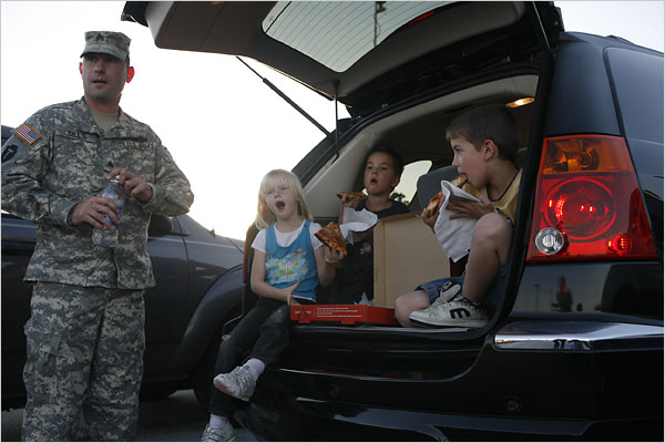 Sergeant Anthony Sills waits with his van and his children in the Fort Hood Bernie Beck Gate parking lot as the base was closed after Major Malik Nidal Hasan, committed the Fort Hood military base massacre, Texas, November 5, 2009.