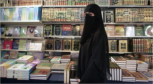 A woman wearing a niqab passes a bookstore at the annual meeting of the Islamic Organizations Union, Le Bourget, the northeastern suburbs of Paris, 2005.