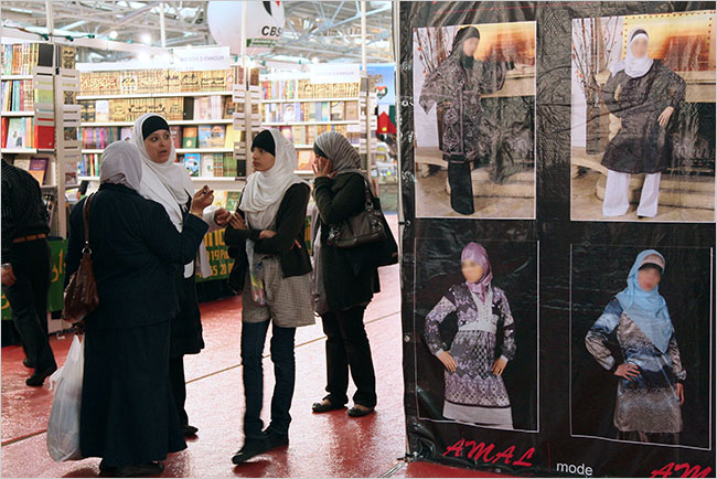 Women wearing veils pass a bookstore at the annual meeting of the Islamic Organizations Union, Le Bourget, the northeastern suburbs of Paris, April 2009.