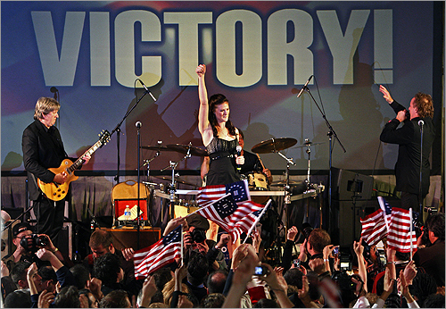 Supporters of Scott Brown, Republican candidate for the Senate, wave the Betsy Ross version of US flag with 13 stars, as Mr. Brown's daughter, Ayla, sings, Park Plaza Hotel, Boston, Massachusetts, January 19, 2010.