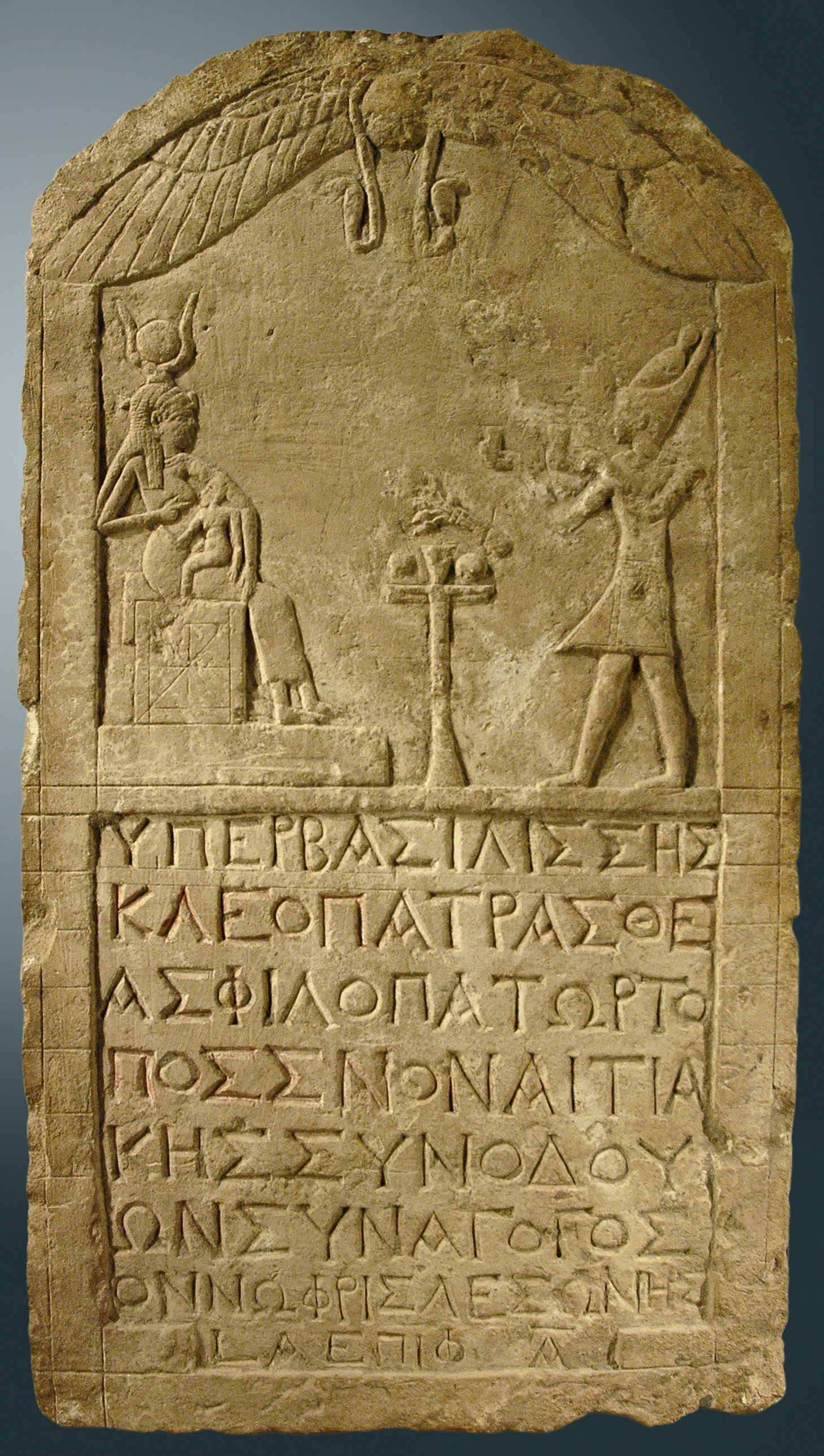 Cleopatra VII of Egypt dressed like a pharaoh presenting offerings to Isis, 51 BCE, limestone stele dedicated by a Greek man named Onnophris, Louvre Museum, Paris.
