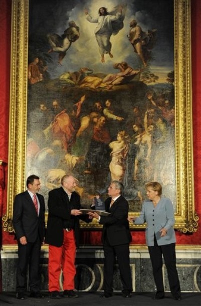 The former head of the state-funded body which manages the archives of the former East German secret police Stasi Joachim Gauck congratulates Danish cartoonist Kurt Westergaard, second left, who in 2005 drew the most controversial of 12 caricatures of the Prophet Muhammad, on receiving the M100 Media Prize 2010, as German Chancellor Angela Merkel, right, and Potsdam's mayor Jann Jakobs, look in, Potsdam, near Berlin, eastern Germany, September 8, 2010.