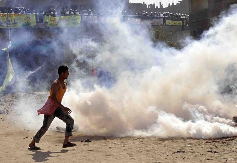Anti-riot forces use tear bombs against Christians who violently demonstrated against suspending the building of the unlawful The Angel and the Virgin Church, Omraneya, Giza, Egypt, November 24, 2010.