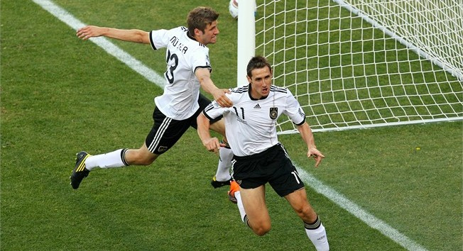 Germanys Miroslav Klose, right, celebrates with Thomas Mueller, after scoring the first goal against England, a match Germany to win 4-1 and reach the quarterfinals of the 2010 World Cup, Bloemfontein, South Africa, June 27, 2010.