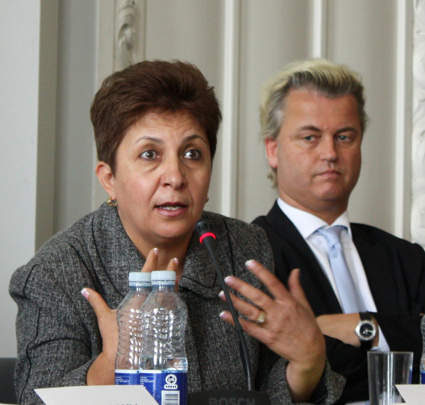 American psychiatrist and anti-Islam activist Wafaa Sultan addresses the Danish Free Press Society during the 'Free Speech and Islam' conference, as Dutch Parliament member Geert Wilders looks in, Copenhagen, Denmark, June 14, 2009.