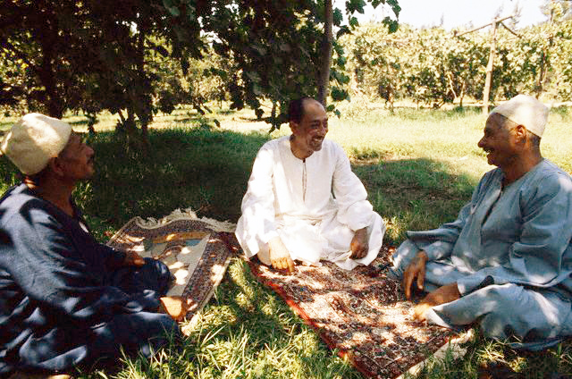 Egyptian President Anwar A-Sadat with folks in his home-village Mit Abul-Kum, Al-Munufiyah, Egypt, c. 1977.