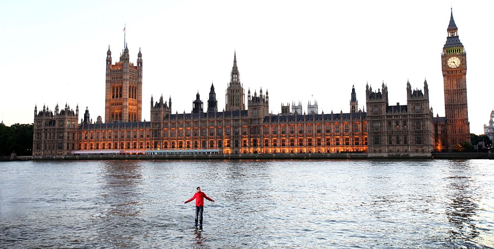 Before heading towards the Houses of Parliament, Steve Frayne or Magician Dynamo poses while standing in the middle of the River Thames where he performs an illusion in which he appears to walk on water, London, June 25, 2011.