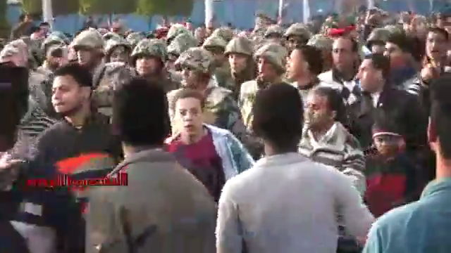 Ordinary Egyptian people, along with Armed Forced and Police in civilian dress, storm A-Tahrir Square to evacuate it from Arab minority invaders, downtown Cairo, Egypt, March 9, 2011.