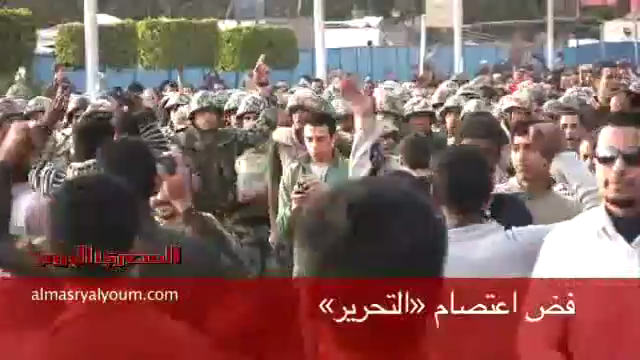 Ordinary Egyptian people, along with Armed Forced and Police in civilian dress, storm A-Tahrir Square to evacuate it from Arab minority invaders, downtown Cairo, Egypt, March 9, 2011.