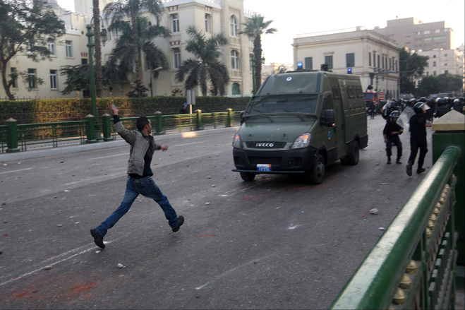 A protester attacks riot police, A-Tahrir Square, downtown Cairo, Egypt, January 25, 2011.