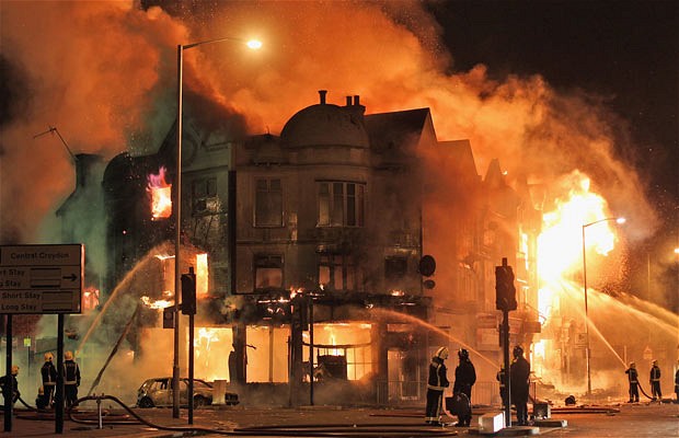 Firefighters battle a large fire that broke out in shops and residential properties in Croydon, London, August 8, 2011.