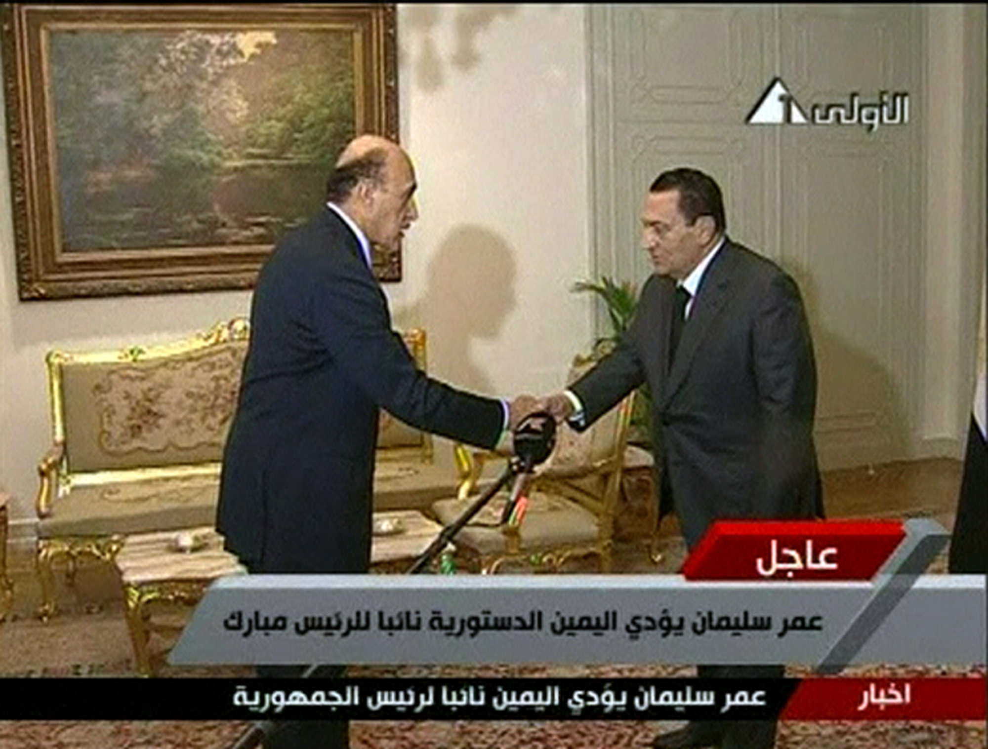 Egyptian President Hosni Mubarak, right, shaking the hand of intelligence chief Omar Suleiman, after he sworn in as vice-president, in this still image taken from TV, Cairo, January 29, 2011.