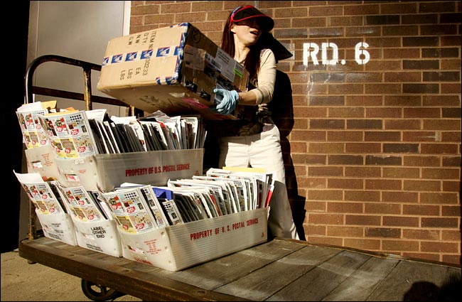 Eady M. C. Rodriguez sorts mail before starting her deliveries, Somerset post office, New Jersey, December 2004.