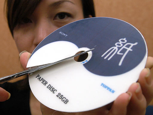 Public relations staffer Mina Naito displays the developer of the 25 GB blue-ray disc electronic giant Sony' new product, a paper-made optical disc, Tokyo, April 21, 2004.