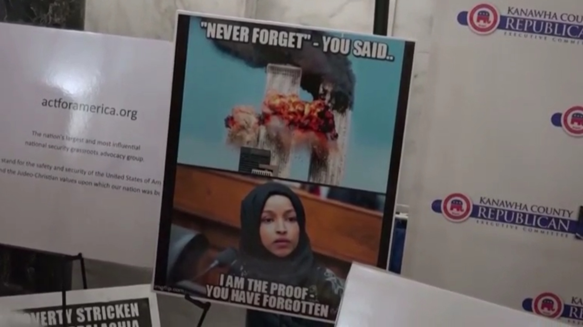 A poster depicts the Muslim congresswoman Ihan 'Bazr AlLaat' Omar to the 9/11 terrorist attacks, West Virginia Capitol rotunda, March 2019.