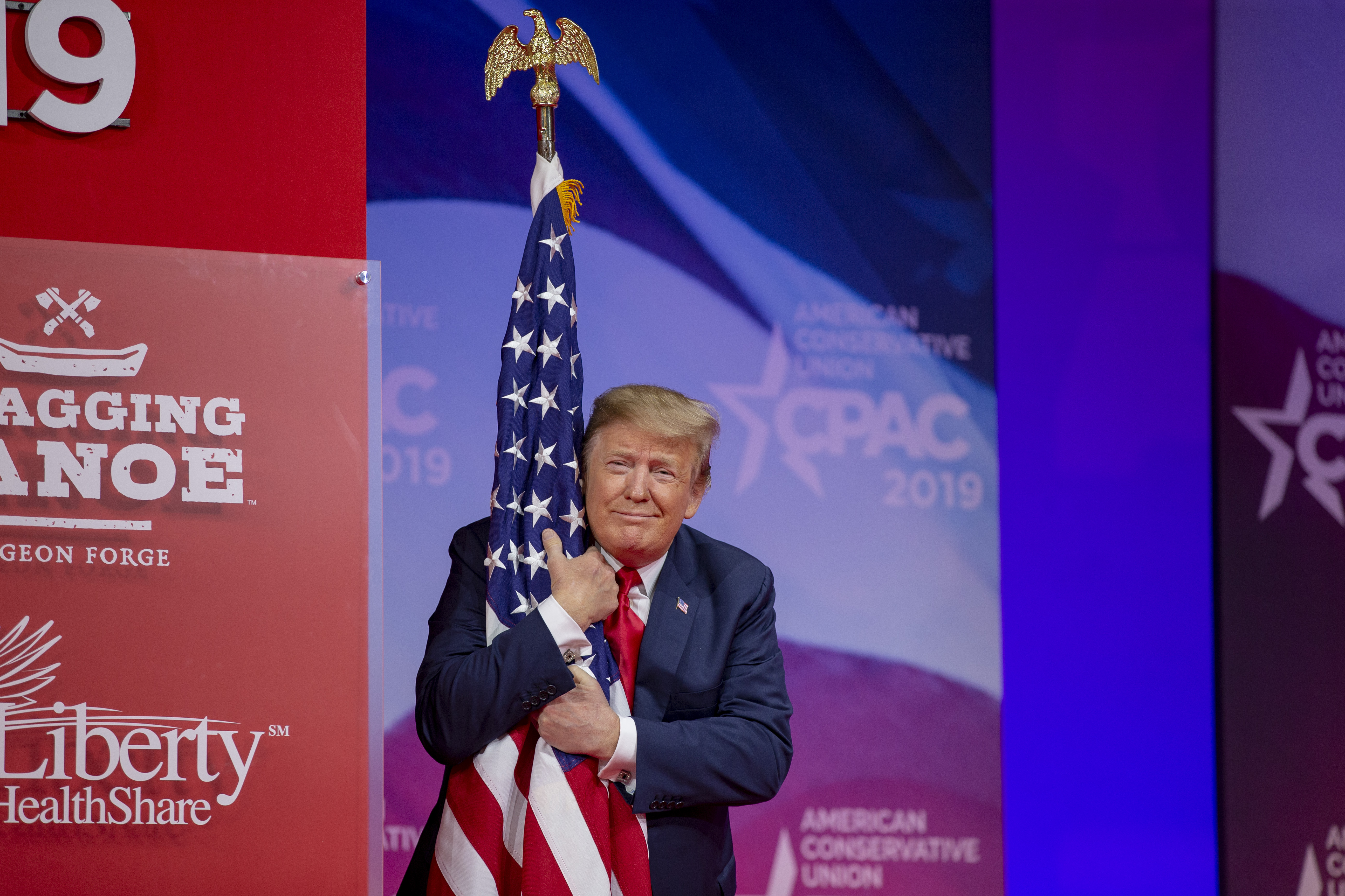 President Trump hugs the American flag as he walked on stage at the 2019 Conservative Political Action Conference (CPAC), March 2, 2019.