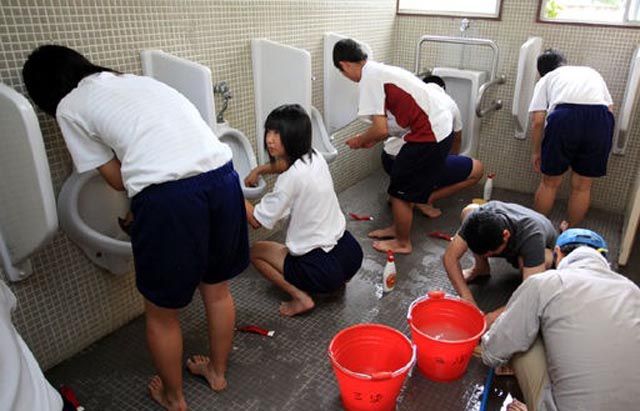 Japanese children and their teachers during the daily cleaning of school.