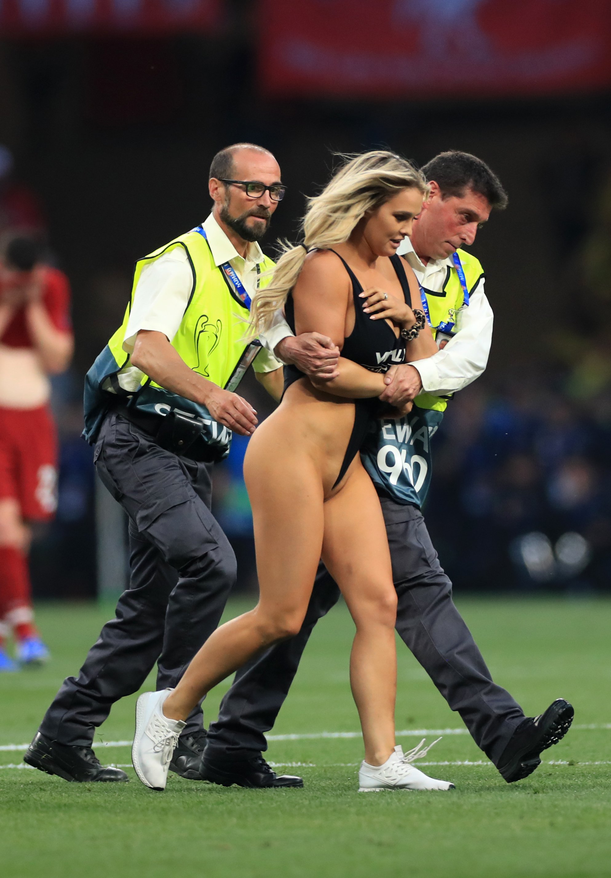 Pitch invader Kinsey Wolanski escorted out of the Wanda Metropolitano Stadium after she wore a skimpy swimsuit advertising a Russian porn pranking website during the UEFA Champions League final between Liverpool and Tottenham Hotspur, Madrid, June 1, 2019.