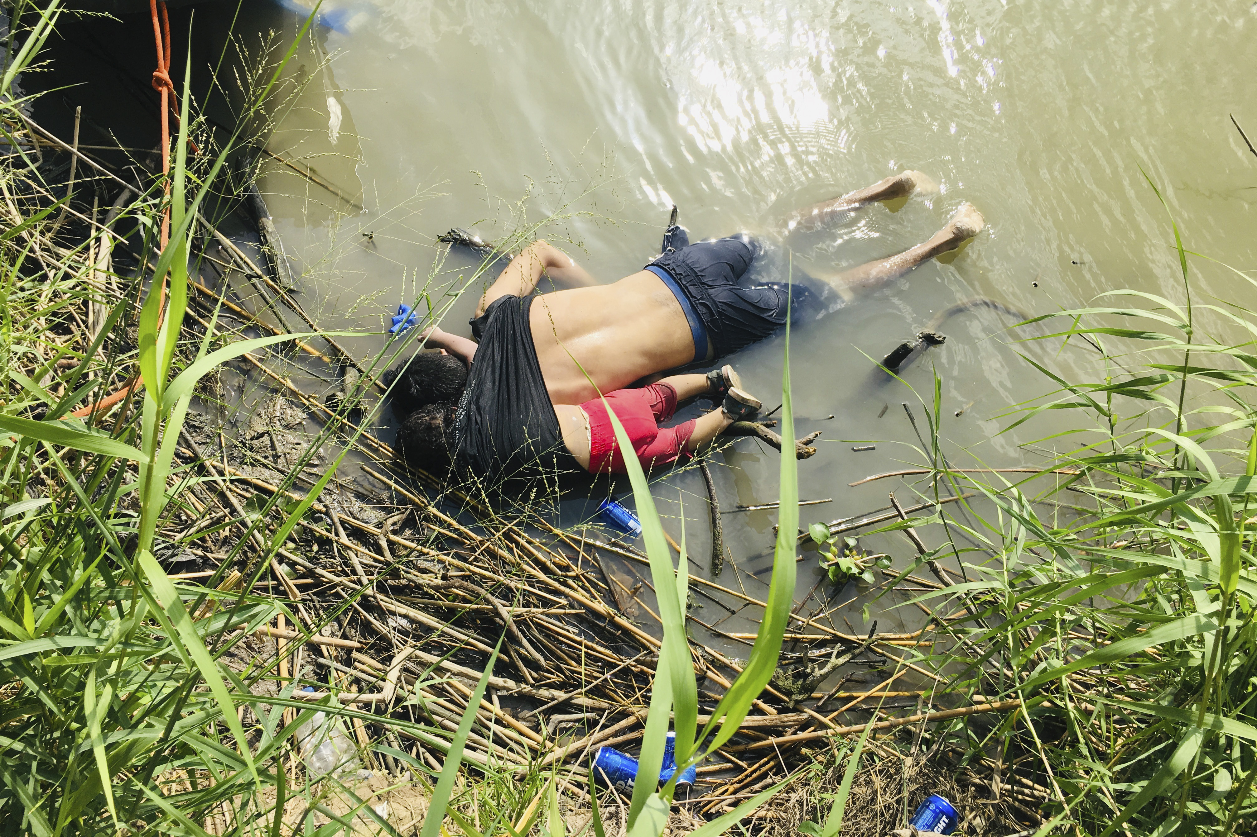 The bodies of Salvadoran migrant Oscar Alberto Martínez Ramírez and his nearly 2-year-old daughter, Valeria, lie on the bank of the Rio Grande in Matamoros, Mexico, after they drowned trying to cross the river to Brownsville, Texas, June 24, 2019.