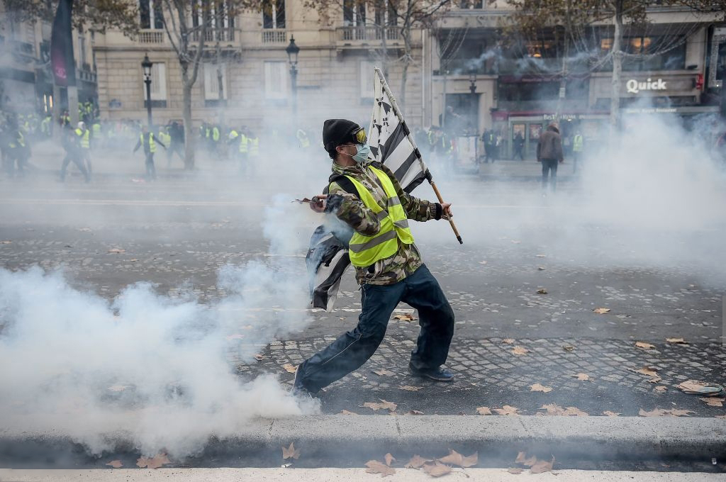 The famed Champs-Elyses avenue speckles in neon as protesters holding flags of France and Brittany don "gilets jaunes' (yellow vests), the French drivers required to keep in their vehicles and become a sort of uniform for the movement against higher fuel costs, Paris, November 24, 2018.